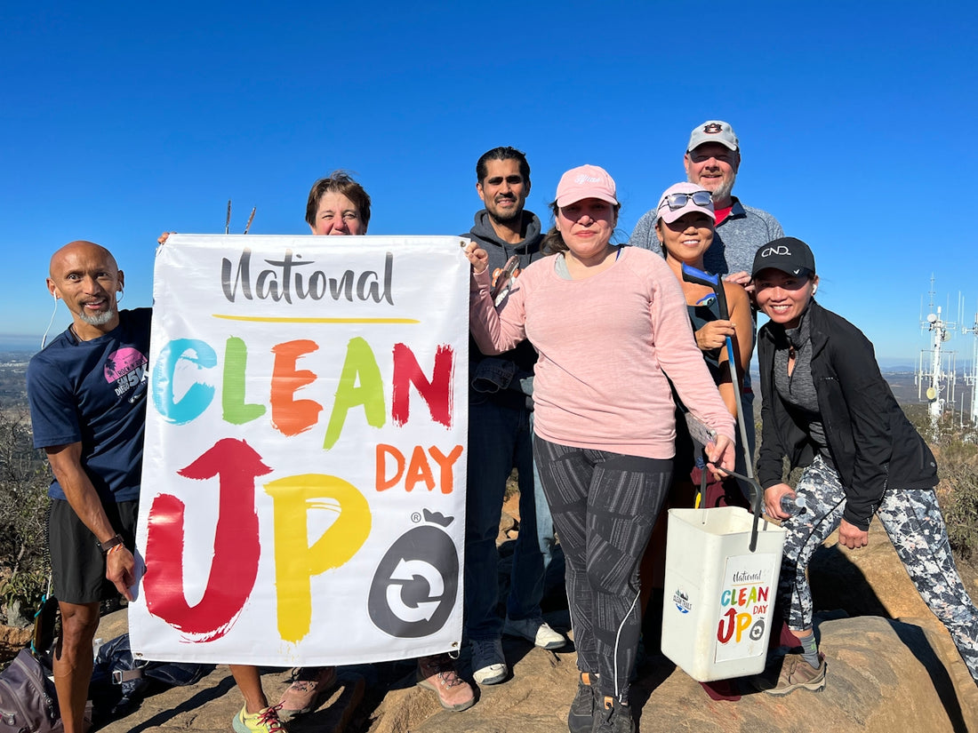 a group of people holding a clean up sign