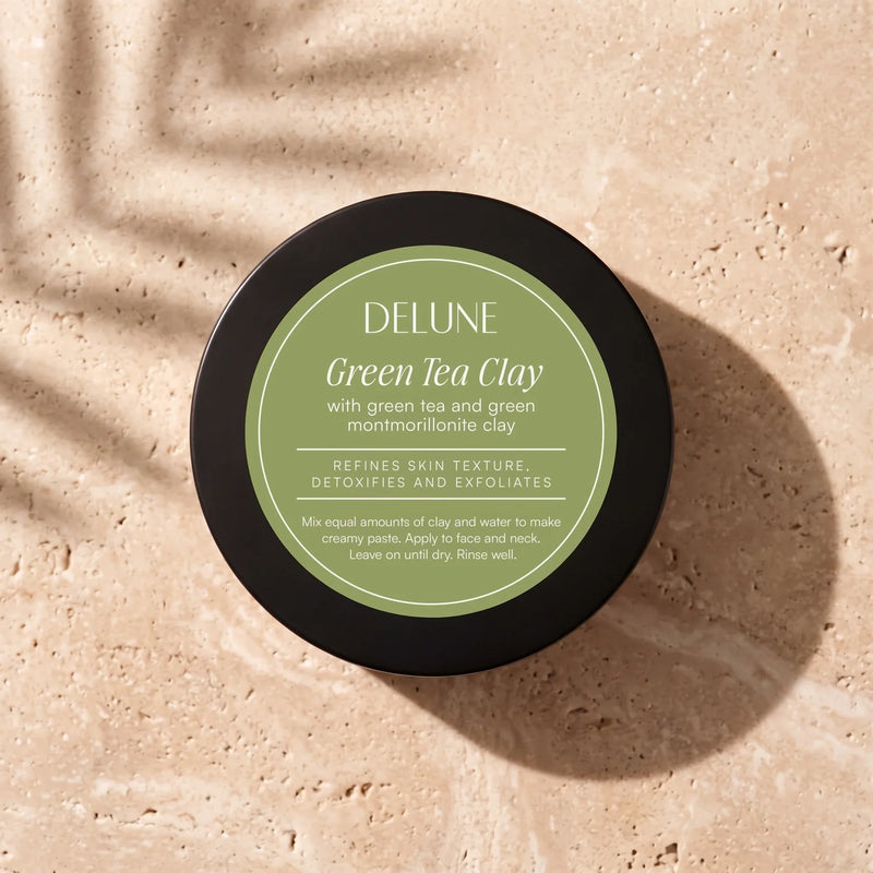 Delune Green Tea Clay Mask jar from above on warm travertine in soft window light
