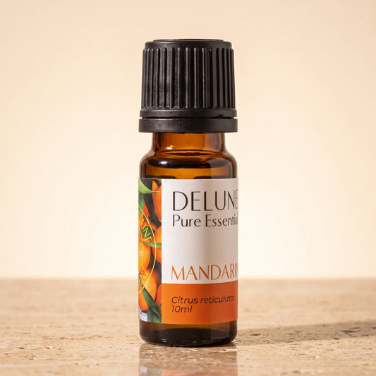 Delune Mandarin Pure Essential Oil, 10ml amber glass bottle on warm travertine stone