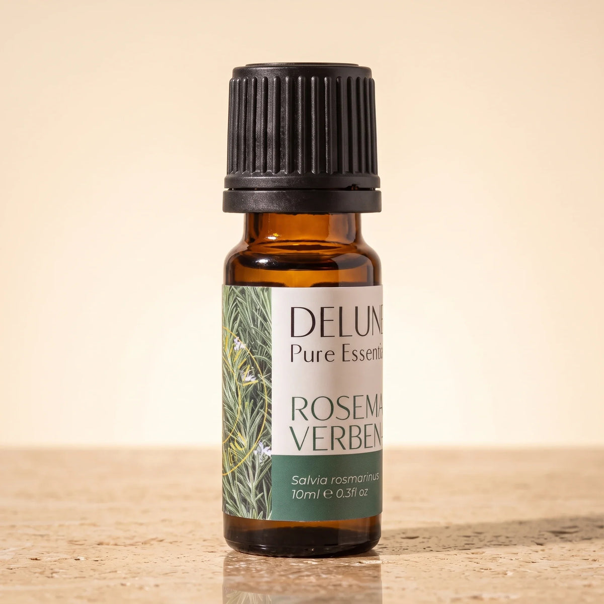 Delune Rosemary Verbenone Pure Essential Oil, 10ml amber glass bottle on warm travertine stone