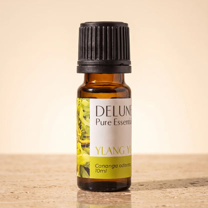 Delune Ylang Ylang Pure Essential Oil, 10ml amber glass bottle on warm travertine stone