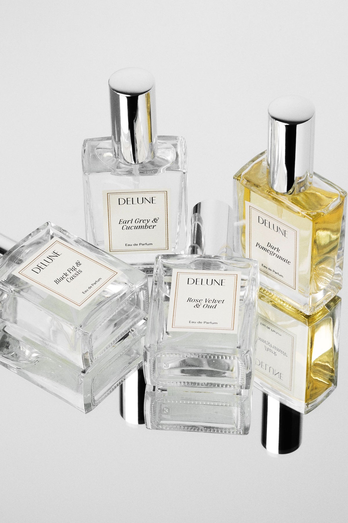 Delune eau de parfum collection: clear glass bottles with silver caps grouped together